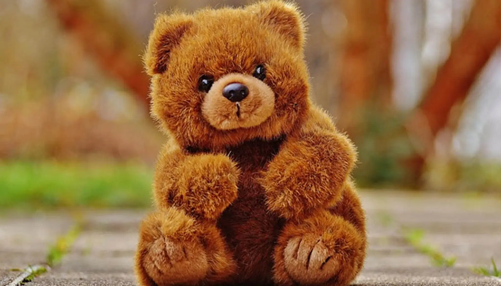 바닥에 앉아있는 작은 곰 인형