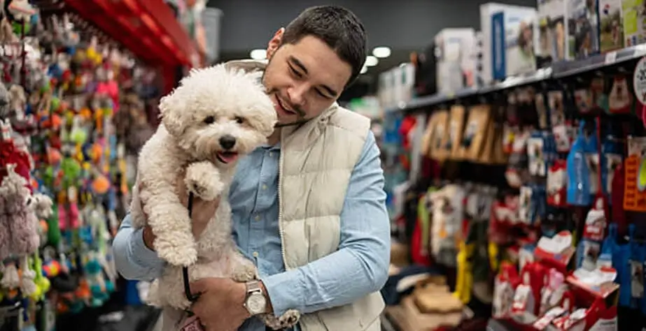 The puppys owner takes the puppy to buy pet toys.