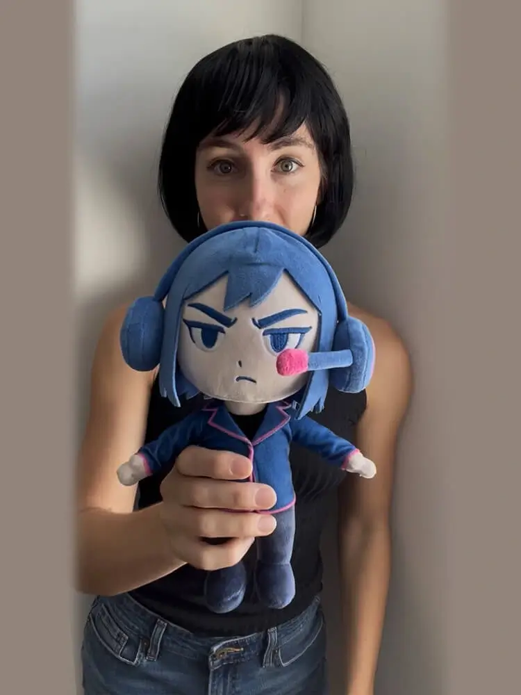 Catie poses with her plush toy, Katuro.