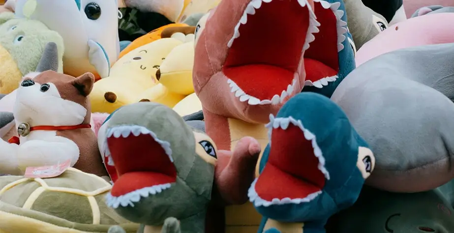 Plush dinosaur toys made by three plush toy manufacturers.